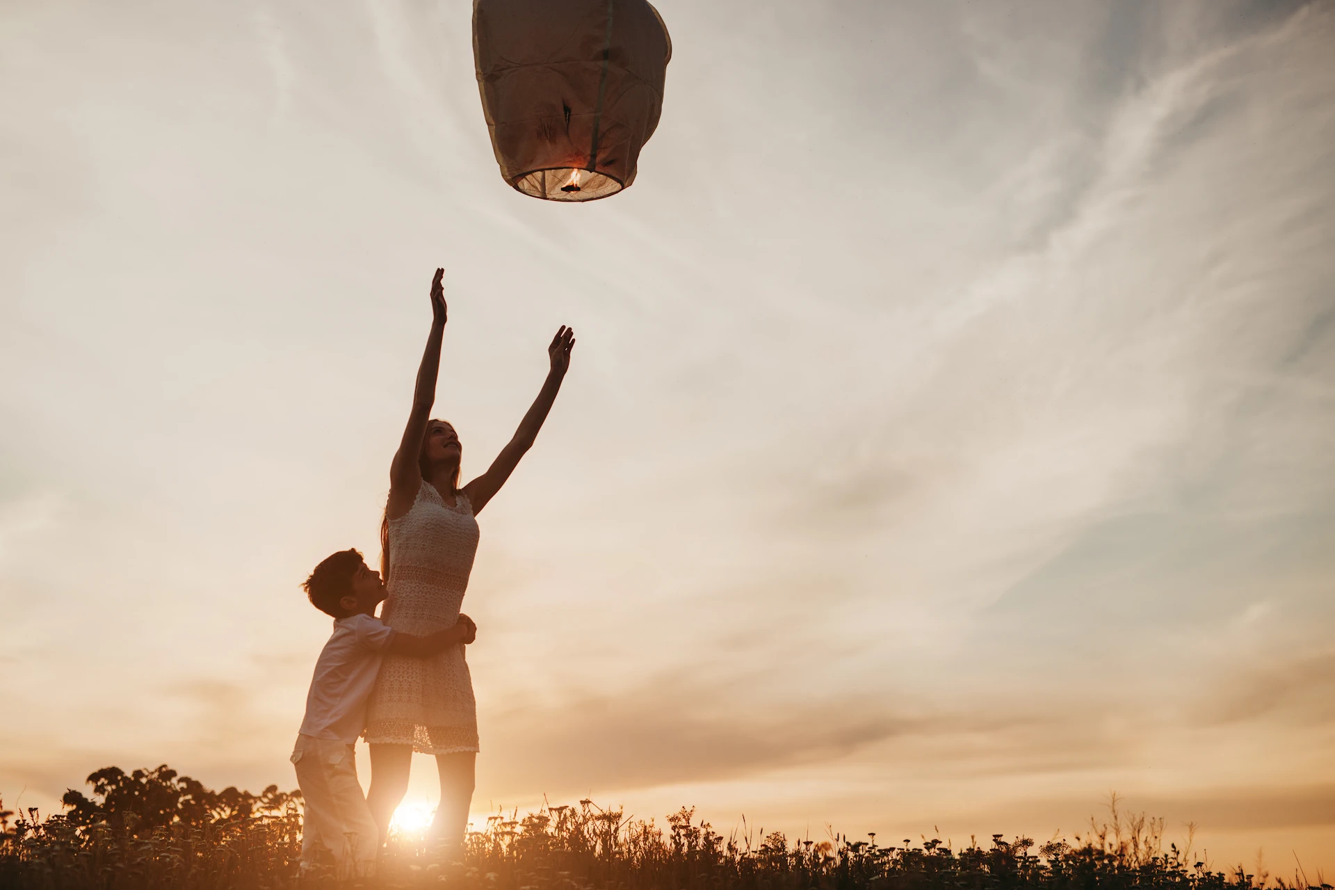 Releasing a Sky Lantern During Sunset