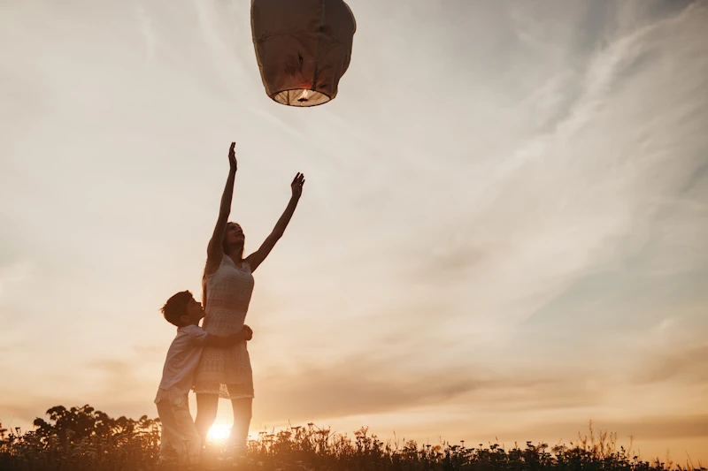 Releasing a Sky Lantern During Sunset